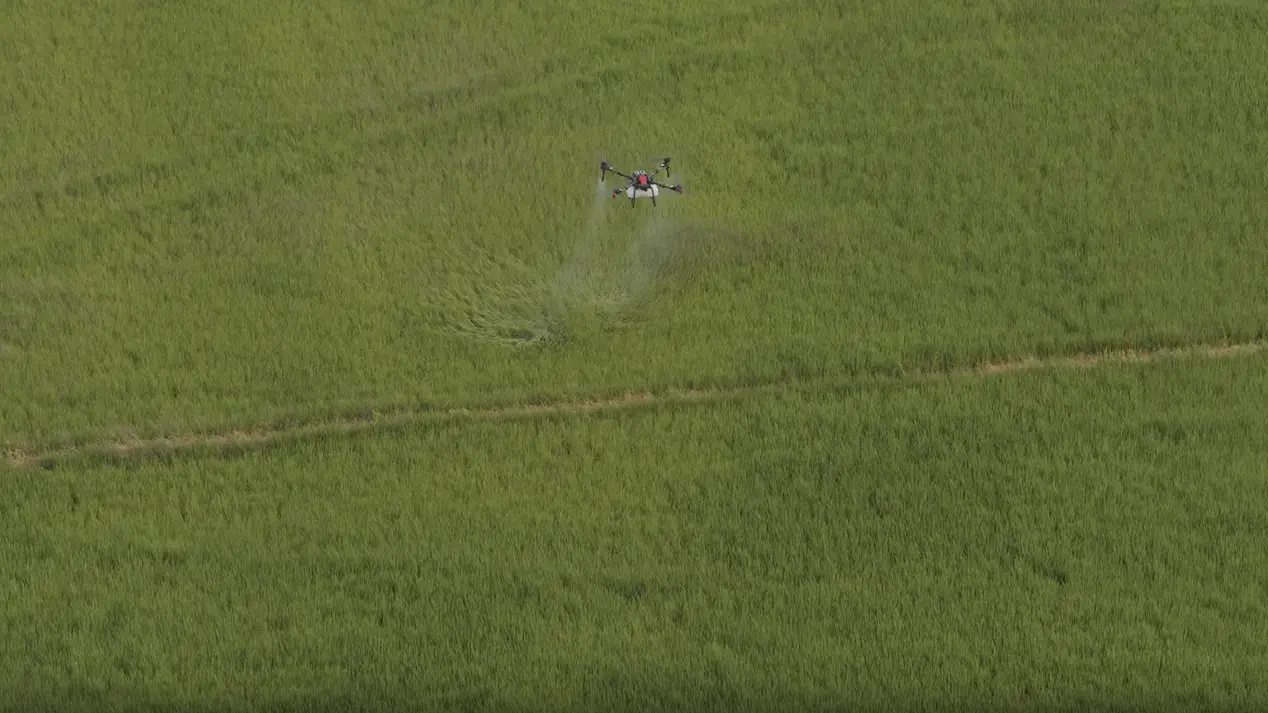 Drone hovers mid air under a blue sky