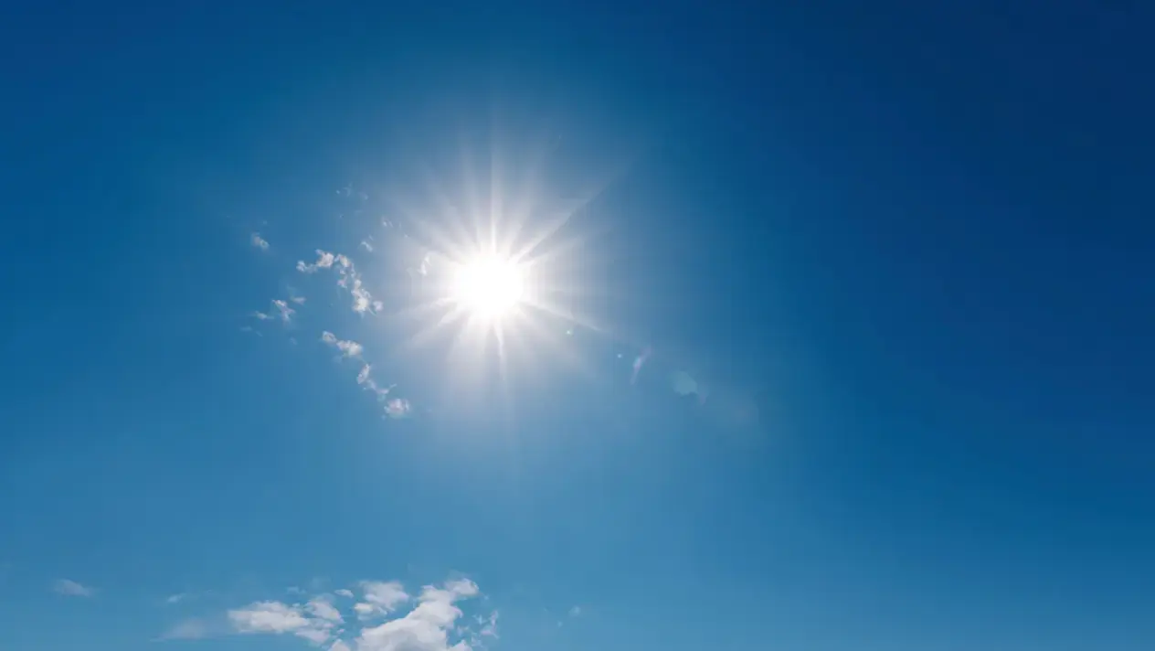 A picture of the sun in a blue sky.