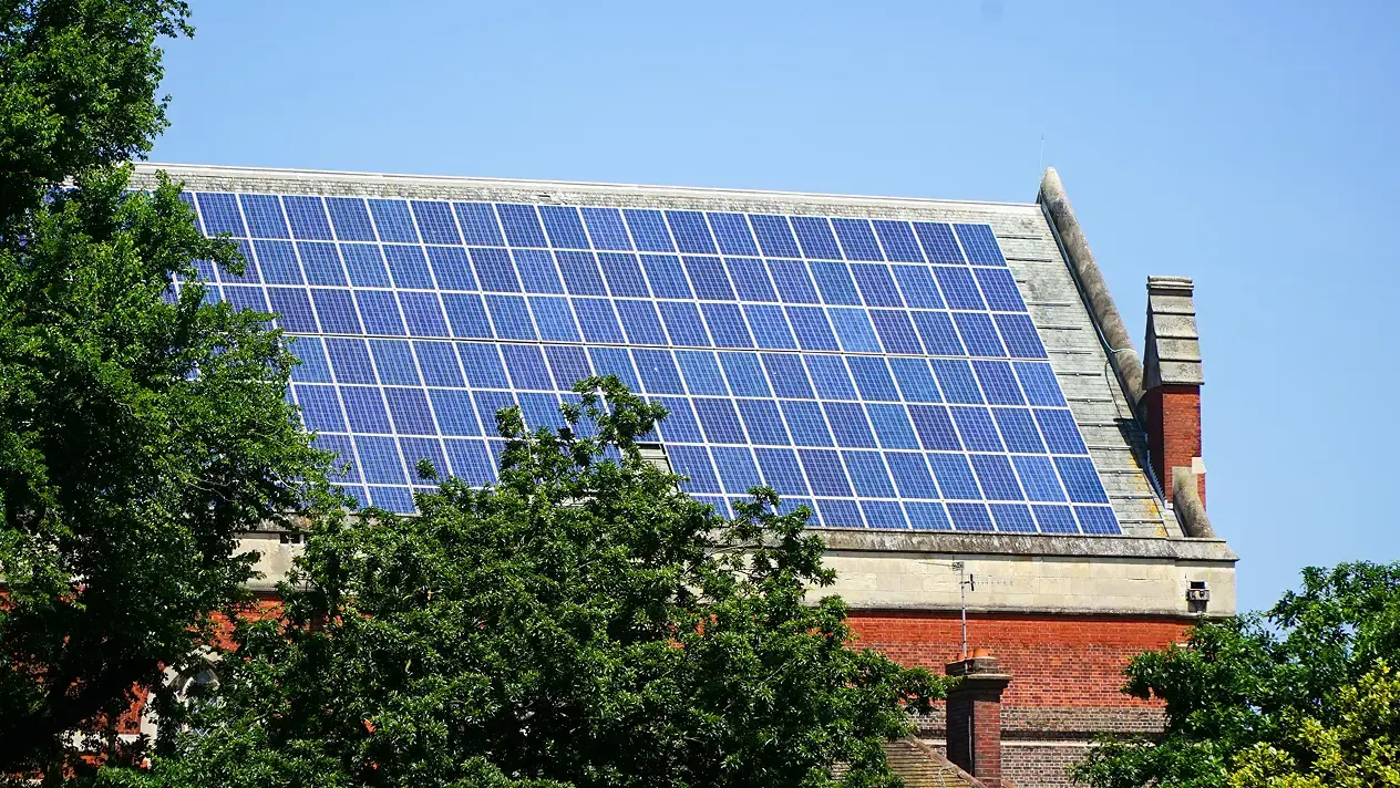 A very high up awkwardly located solar array on a roof.