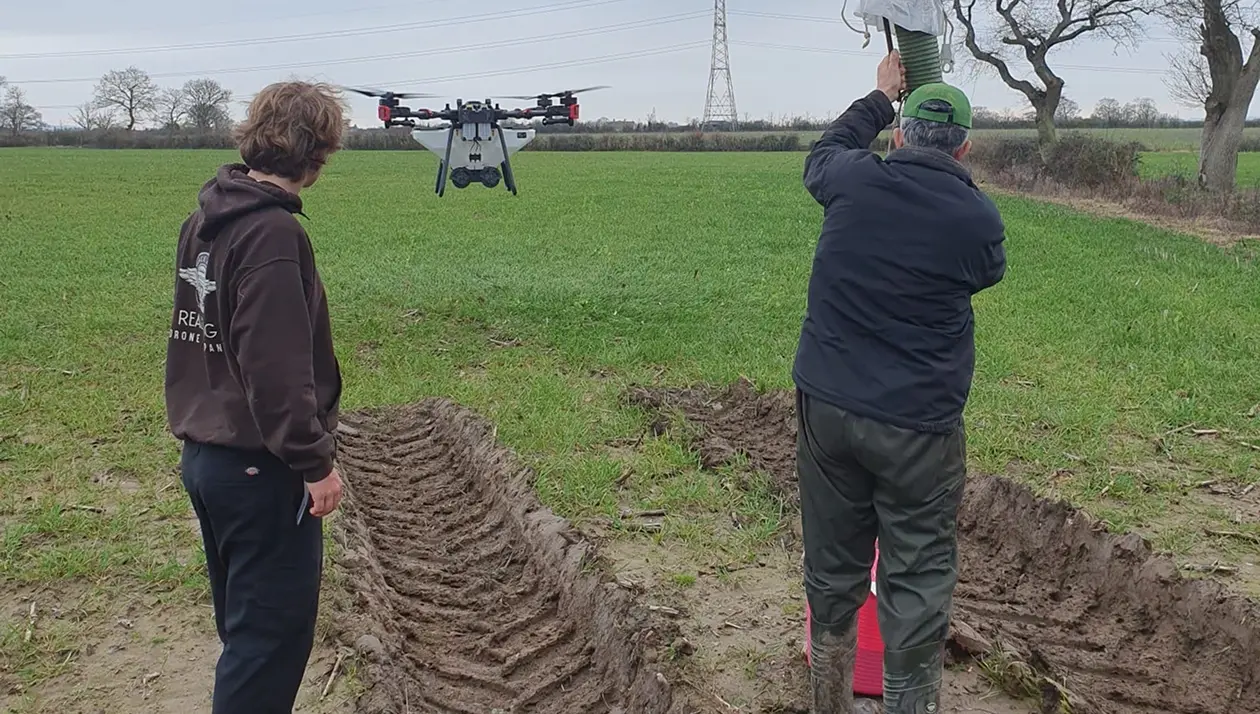 Comparison showing tractor wheel compaction damage in soil cross-section versus zero-contact drone application